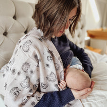 Load image into Gallery viewer, mom breastfeeding with our cotton swaddle blanket as a nursing cover and burp cloth