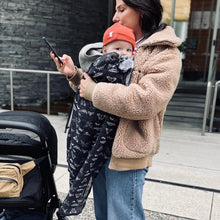 Load image into Gallery viewer, mom wearing baby in a baby carrierwrapped in a black butterfly printmuslin swaddle blanket