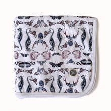 Load image into Gallery viewer, folded jersey baby blanket in gender neutral butterfly deer and shell print