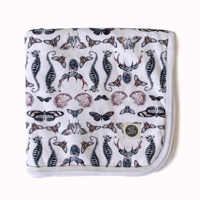 folded jersey baby blanket in gender neutral butterfly deer and shell print
