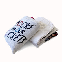 Load image into Gallery viewer, cotton baby blanket in cotton muslin drawstring bag with rocks in our pockets logo
