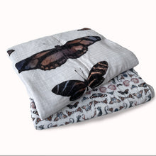Load image into Gallery viewer, 2 quilted baby blankets folded with moth print on the top and deer , seahorse and butterfly  print visible on the bottom
