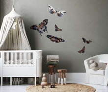 Load image into Gallery viewer, Child&#39;s room iwth white furniture including a white crib with a canopy and armchair. There are butterfly decals on the wall
